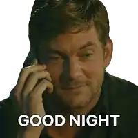 a man talking on a cell phone with the words good night written below him