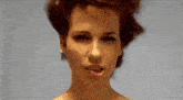 a close up of a woman 's face with her eyes closed
