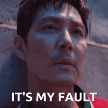 a man leaning against a wall with the words " it 's my fault " written above him