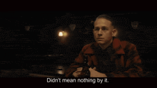 a man sitting at a table with a bottle of beer and the words didn 't mean nothing by it