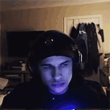 a man wearing headphones and a hat is looking at something