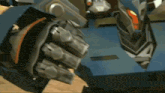 a close up of a robot 's fist with a glove on .