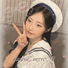 a girl giving a peace sign with the name haseul myre written on the bottom