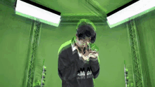 a man wearing a sweater that says ama on it is standing in front of a green wall