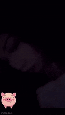 a close up of a woman 's face in the dark with a pig sticker on it .