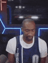 a man wearing a dallas thunders jersey is dancing