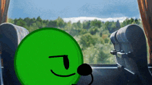 a green cartoon character is sitting in a bus looking out of a window .