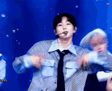 a man wearing a striped shirt and tie is dancing on stage