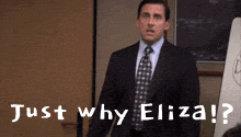 a man in a suit and tie is standing in front of a white board and says just why eliza