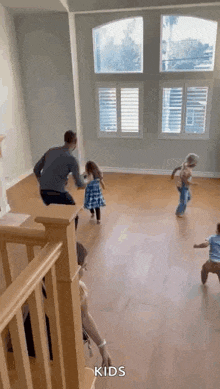 a group of children are playing in a living room .