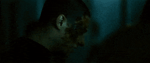 a close up of a man 's face with blood on it .