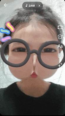 a girl wearing glasses with a time of 2am