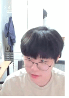 a man wearing glasses and a white shirt looks at the camera with the time 2:43