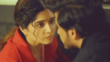 a man and a woman are kissing each other on the nose .