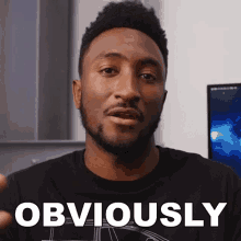 a man in a black shirt says obviously in white letters