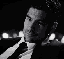 a man in a suit and tie is looking down