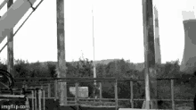 a black and white photo of a rocket being launched from a tower .