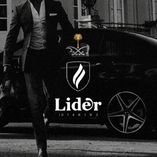 a black and white photo of a man standing next to a black car with the word lider on the bottom