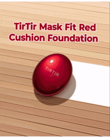 a red cushion foundation is sitting on a wooden surface