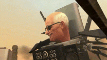 a man wearing glasses is sitting in front of a monitor that says 00:00