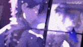 a blurry picture of a person with a purple background