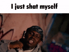 a man with a bandana on his head and the words " i just shat myself " below him