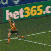 a soccer player is running on the field in front of a bet36 banner