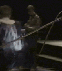 a blurred image of a man playing a guitar on a stage