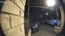 a ring.com camera shows a car parked in front of a brick building