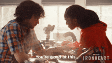 a man and a girl are holding hands and the girl says " you 're good at this ironheart "