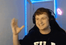 a man wearing headphones and a shirt that says fin on it