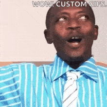 a man wearing a blue striped shirt and tie is making a surprised face .