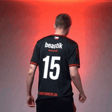 a man is wearing a black jersey with the number 15 on it