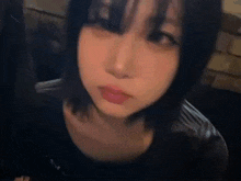 a close up of a woman 's face with a black shirt on .