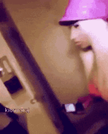 a person wearing a pink hard hat with the name kiornaraj on the bottom