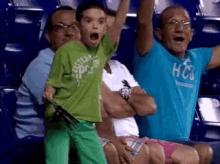 a young boy wearing a green shirt that says amsterdam on it