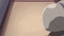 a teddy bear is standing in front of a wall and looking at something .