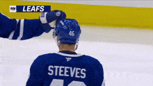 a hockey player wearing a blue jersey with the name steeves on the back