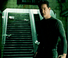a man is standing in front of a set of stairs and a sign that says 83 35 st