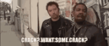 two men are standing next to each other on a sidewalk and one of them is asking the other if he wants some crack .