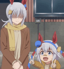 a woman and a child are standing next to each other and giving a peace sign