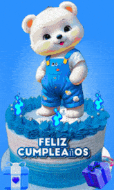 a teddy bear on top of a cake that says feliz cumpleaños