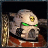 a close up of a video game character 's helmet with green eyes and a skull on it .