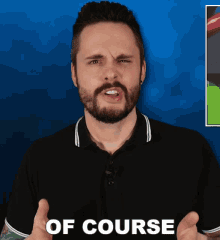 a man with a beard is wearing a black shirt that says of course on the front