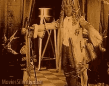 a black and white photo of a man in a costume with the website movies silently.com written on the bottom