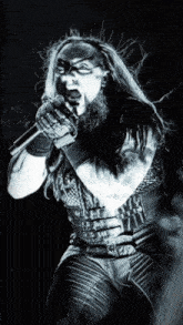 a man with a beard singing into a microphone