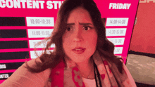 a woman standing in front of a sign that says content studio friday
