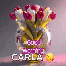 a bouquet of flowers in a vase with the words good morning carla