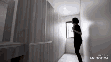 a woman standing in a hallway with the words made in animotica on the bottom