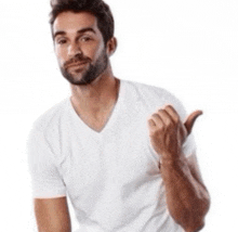 a man with a beard wearing a white t-shirt is giving a thumbs up sign .